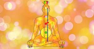 Meditating figure with aligned chakra system, energy channels, and glowing spiritual symbols on an orange background