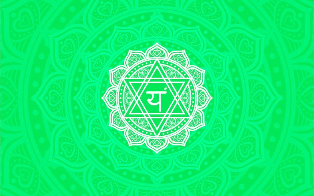Heart chakra or anahata chakra symbol in green mandala background representing love, compassion, and connection