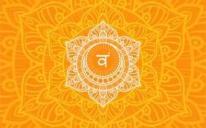 Sacral or svadhistana chakra symbol in orange mandala background representing creativity, pleasure, and emotions